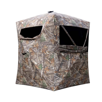 Camouflage hunting blind for archery and bowhunting, designed for concealment in natural terrain.