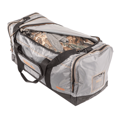 Durable archery gear bag with camouflage clothing for hunting trips.